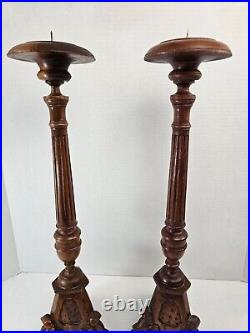 Pair of antique hand carved wooden candlestick holders used in church alter